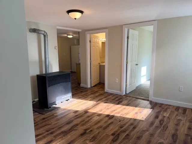 a view of a room with wooden floor and bathroom