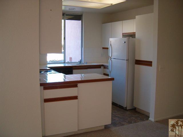 401 El Cielo Road, Unit 29 Palm Springs, CA 92262 - Photo 3 of 25 a kitchen with a sink and a refrigerator