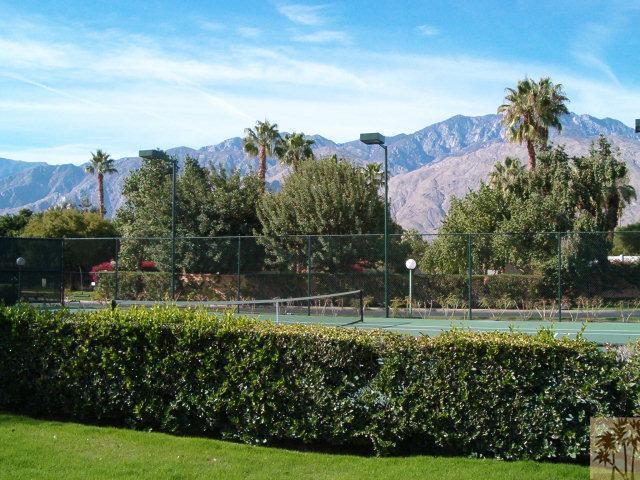 401 El Cielo Road, Unit 29 Palm Springs, CA 92262 - Photo 22 of 25 a view of a garden with a building in the background
