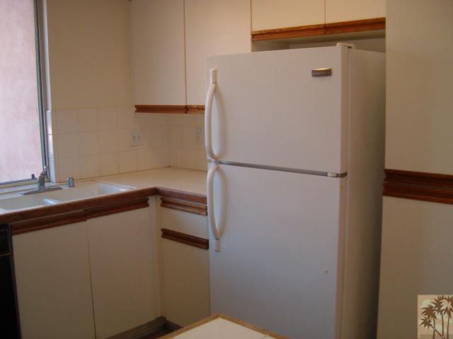 401 El Cielo Road, Unit 29 Palm Springs, CA 92262 - Photo 4 of 25 a white refrigerator freezer sitting inside of a kitchen