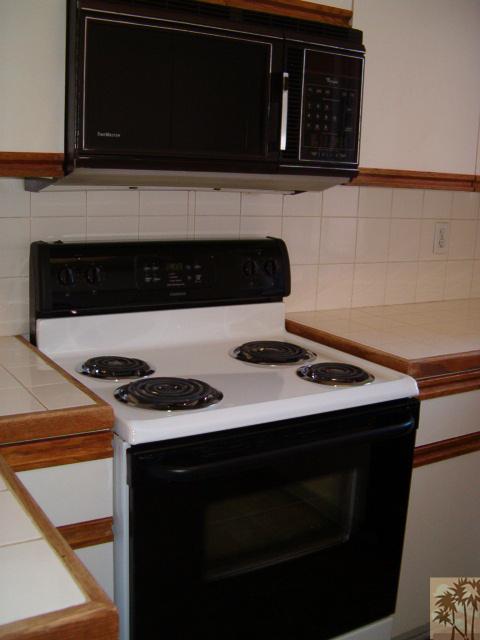 401 El Cielo Road, Unit 29 Palm Springs, CA 92262 - Photo 6 of 25 a kitchen with a stove and a microwave