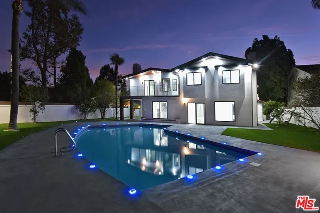 a view of a house with a swimming pool with a yard