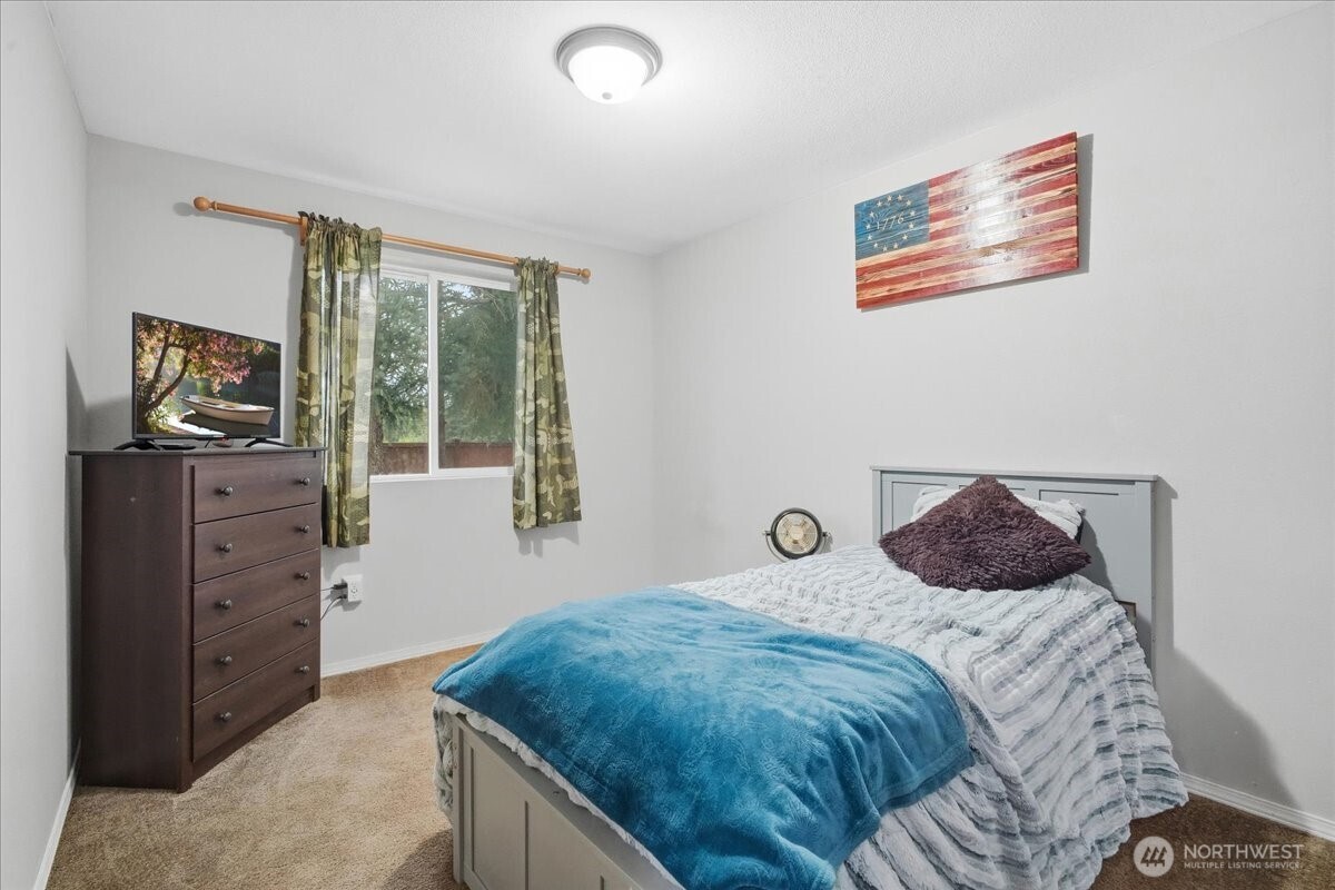 966 South Military Road Winlock, WA 98596 - Photo 18 of 31 a bedroom with a bed and wooden floor