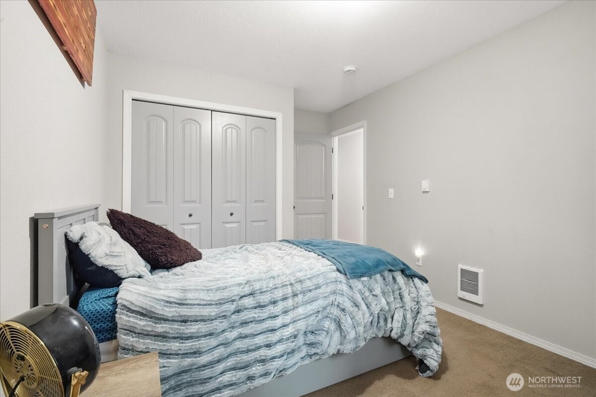 966 South Military Road Winlock, WA 98596 - Photo 19 of 31 a bedroom with a bed and wooden floor