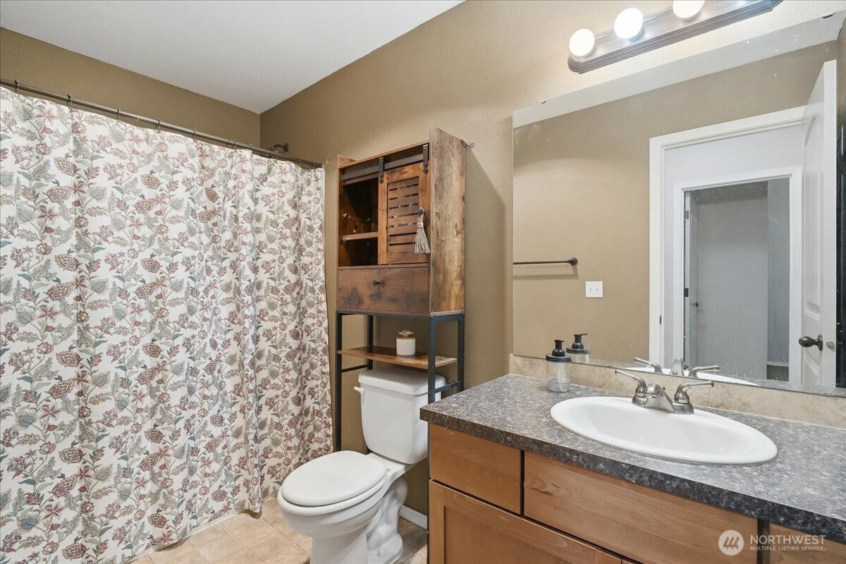 966 South Military Road Winlock, WA 98596 - Photo 20 of 31 a bathroom with a granite countertop sink toilet and shower