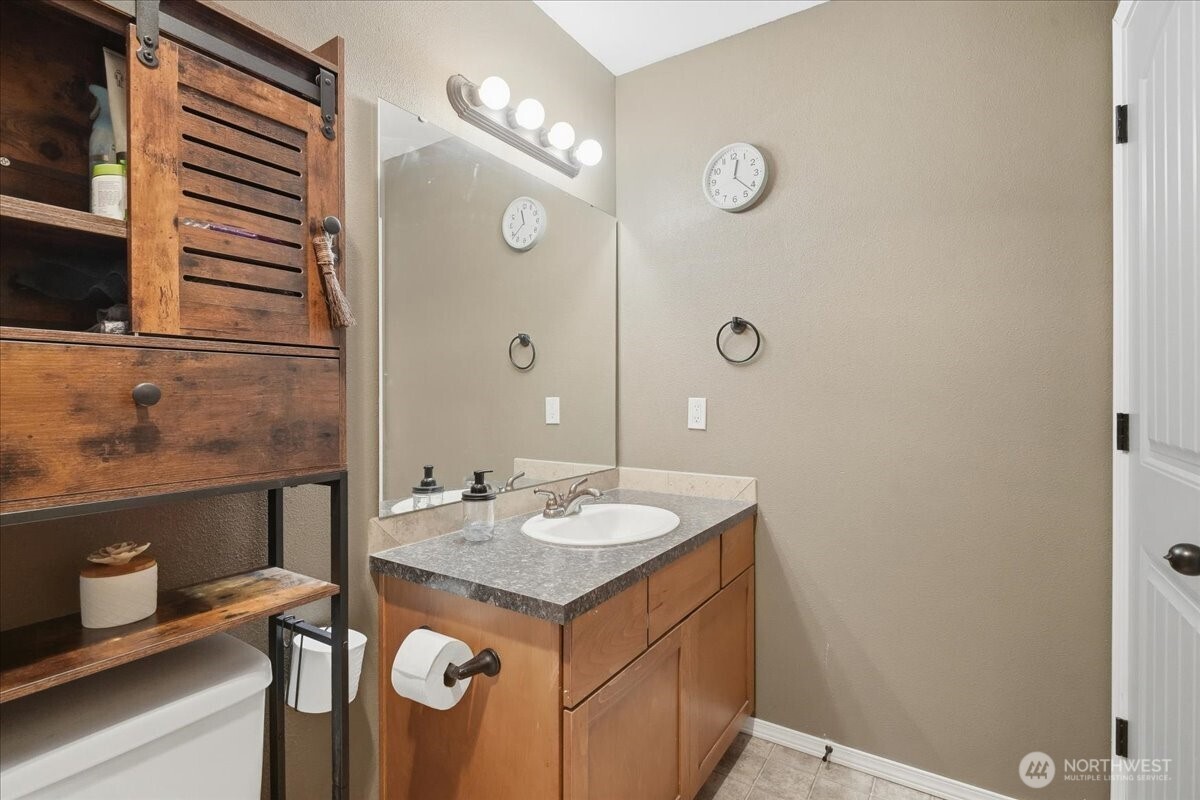 966 South Military Road Winlock, WA 98596 - Photo 21 of 31 a bathroom with a sink vanity and a mirror