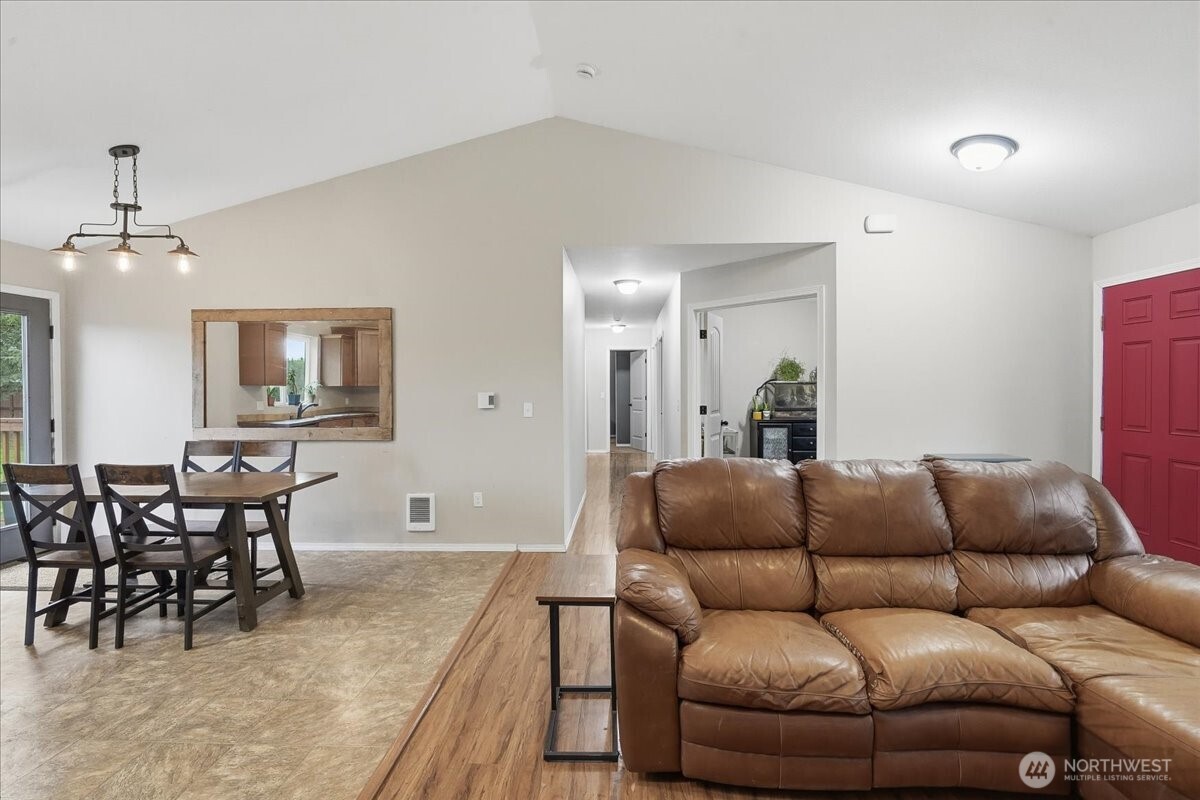 966 South Military Road Winlock, WA 98596 - Photo 9 of 31 a living room with furniture a dining table and chairs with wooden floor