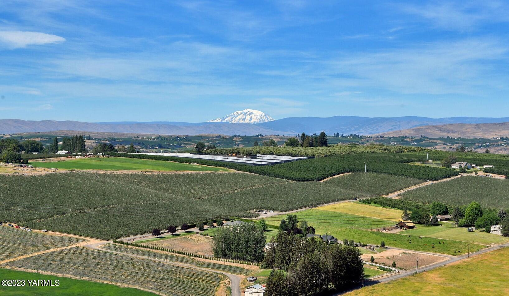1520 Valhalla Loop Selah, WA 98942 - Photo 2 of 7 an aerial view of a city with lots of residential buildings ocean and mountain view in back
