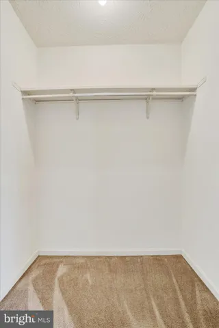a view of a closet with wooden floor