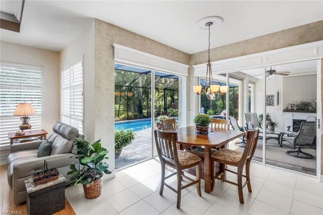 a dining room with furniture wooden floor and a chandelier