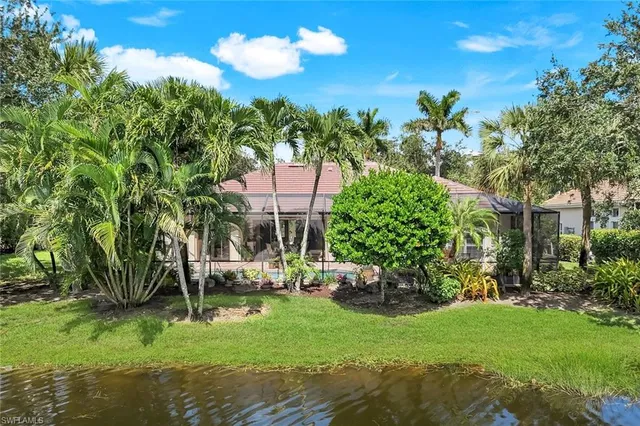 an aerial view of residential houses with outdoor space and river