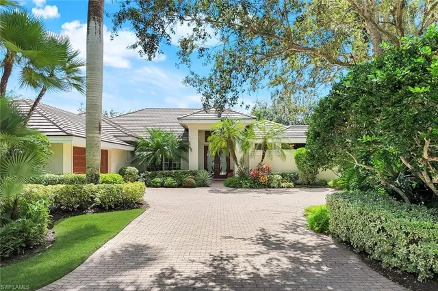 a front view of a building with trees