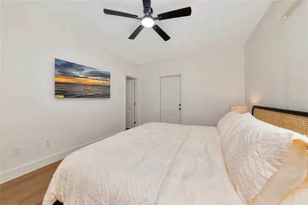 a bedroom with a bed and a painting on the wall