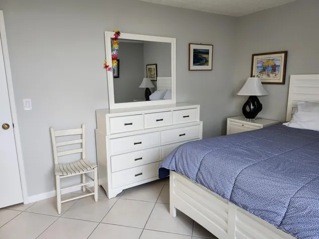 a bedroom with a bed and a dresser