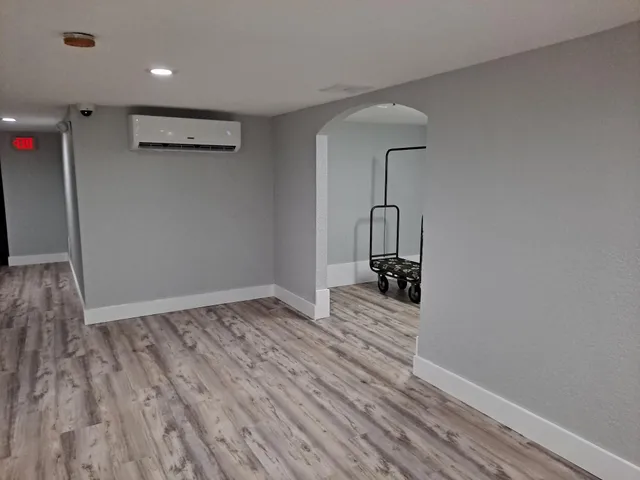 a view of empty room with wooden floor