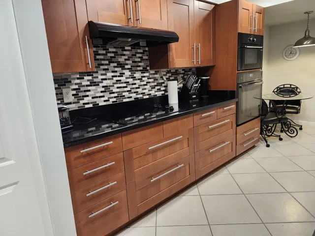 a kitchen with granite countertop a stove and a sink