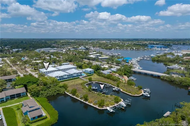 an aerial view of residential houses with outdoor space and lake view
