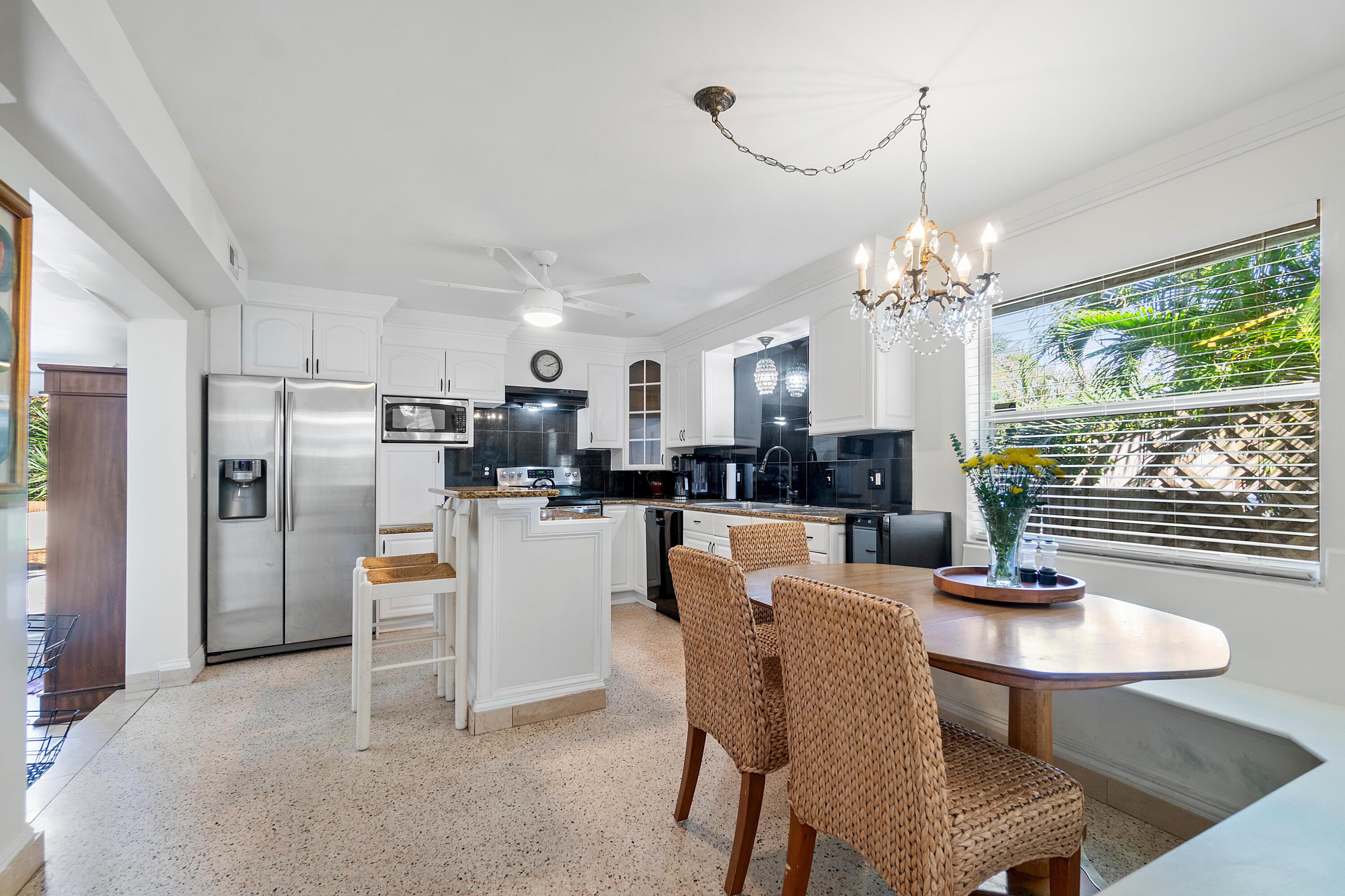 321 Forsyth Street Boca Raton, FL 33487 - Photo 5 of 20 a dining room with furniture a kitchen and chandelier