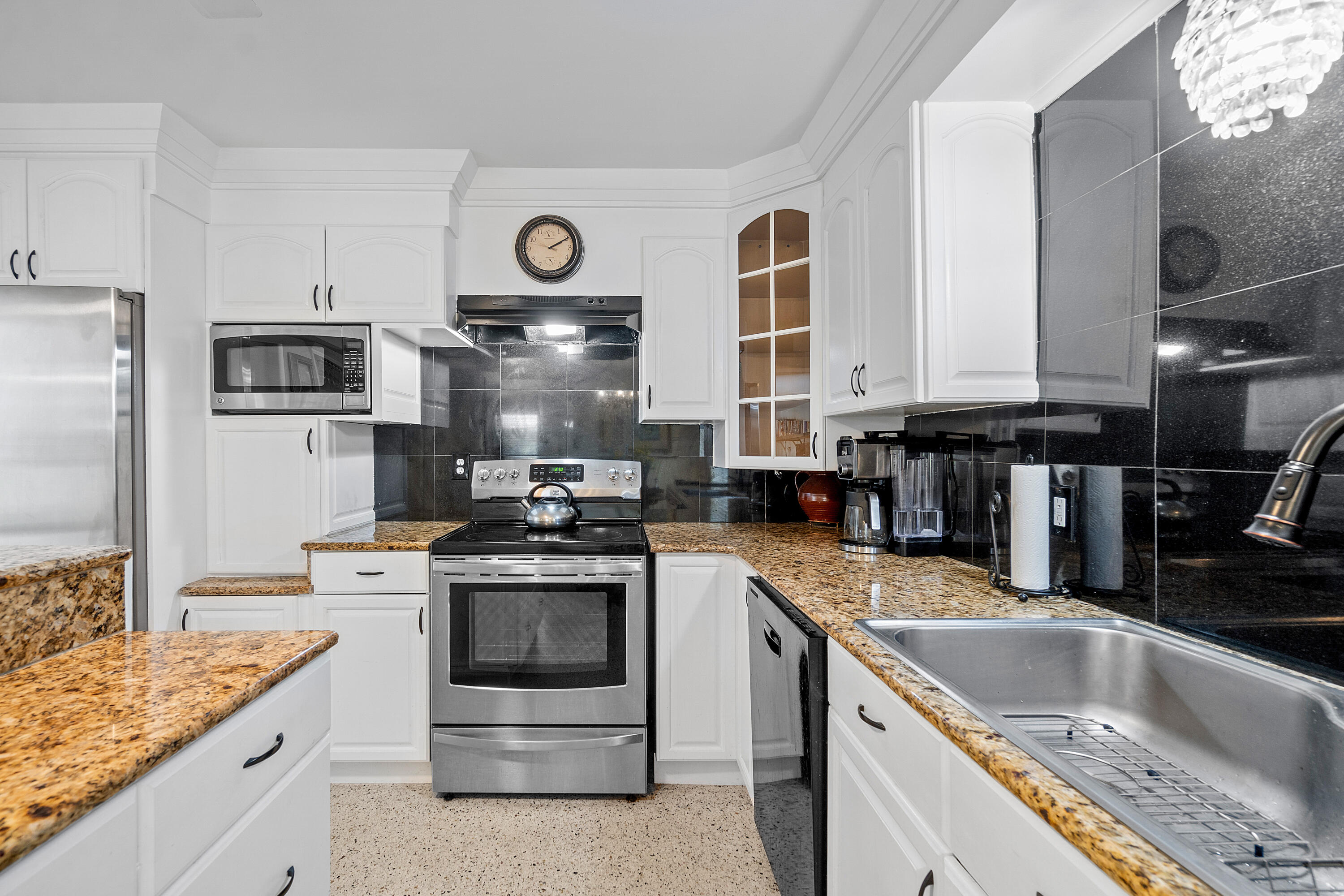 321 Forsyth Street Boca Raton, FL 33487 - Photo 8 of 20 a kitchen with stainless steel appliances granite countertop a sink stove oven and refrigerator