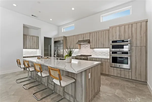 a kitchen with appliances cabinets and furniture