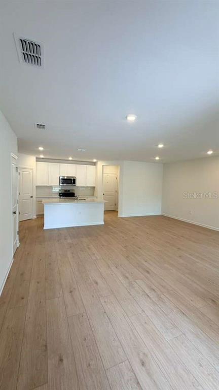 5174 Clay Whaley Road St. Cloud, FL 34772 - Photo 6 of 25 a view of empty room with wooden floor