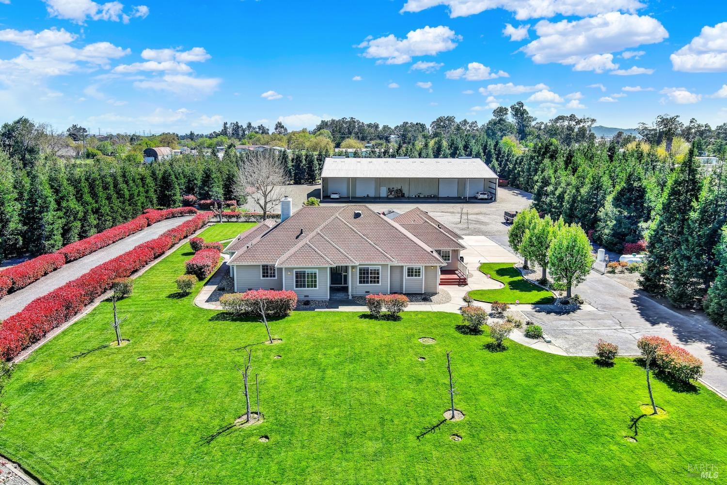 a aerial view of a house with swimming pool and yard