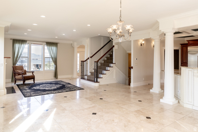 434 Cardon Ridge Drive Smithfield, UT 84335 - Photo 8 of 59 Foyer entrance featuring decorative columns, ornamental molding, and hanging lights