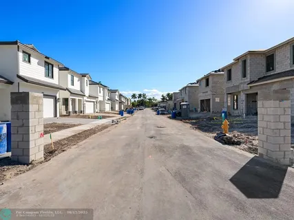 a view of a patio with a table and chairs under an umbrella