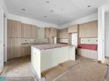 a view of kitchen with furniture and refrigerator