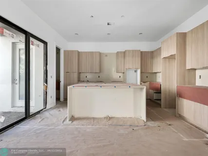 a room with a wooden floor and white doors