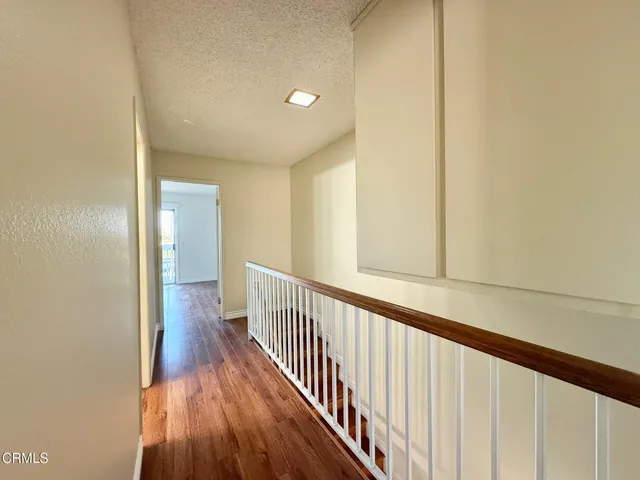 a view of an empty room and wooden floor and glass door