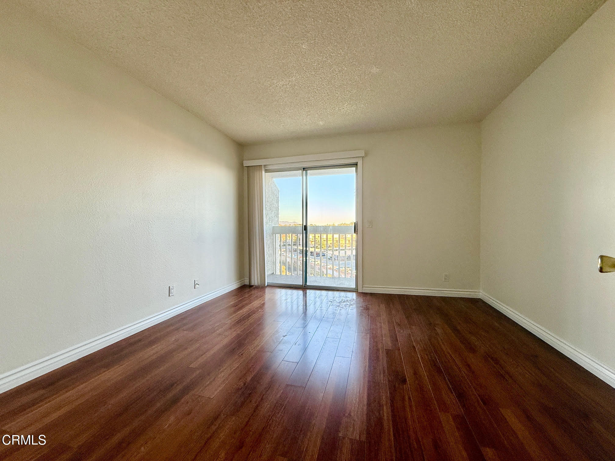 259 South Ventura Road, Unit 254 Port Hueneme, CA 93041 - Photo 17 of 30 a view of an empty room and wooden floor and glass door