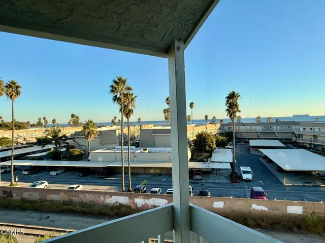 a big room with wooden floor and bathroom view