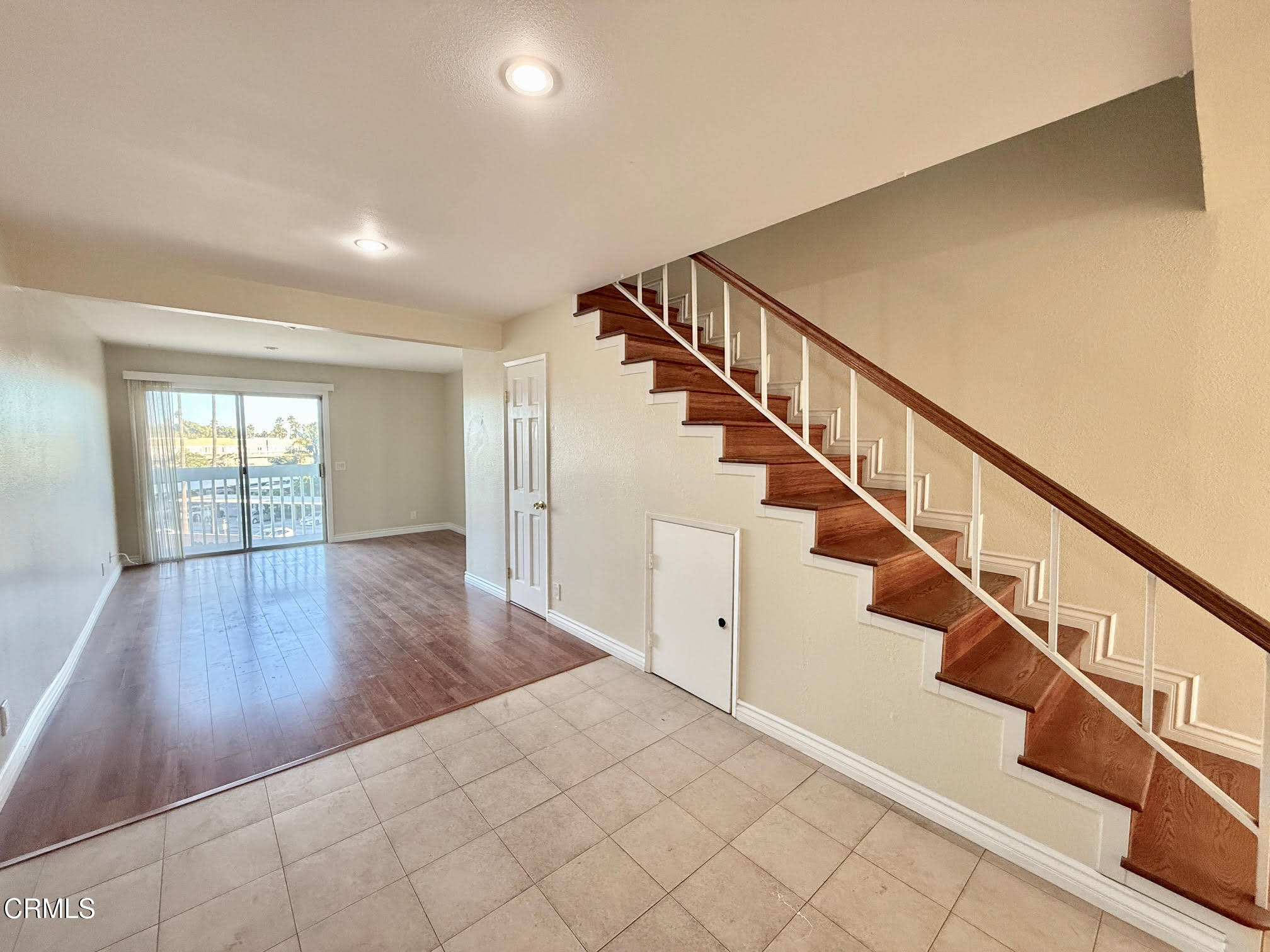 259 South Ventura Road, Unit 254 Port Hueneme, CA 93041 - Photo 4 of 30 a view of staircase with wooden floor and white walls