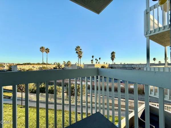 a view of a balcony with chairs