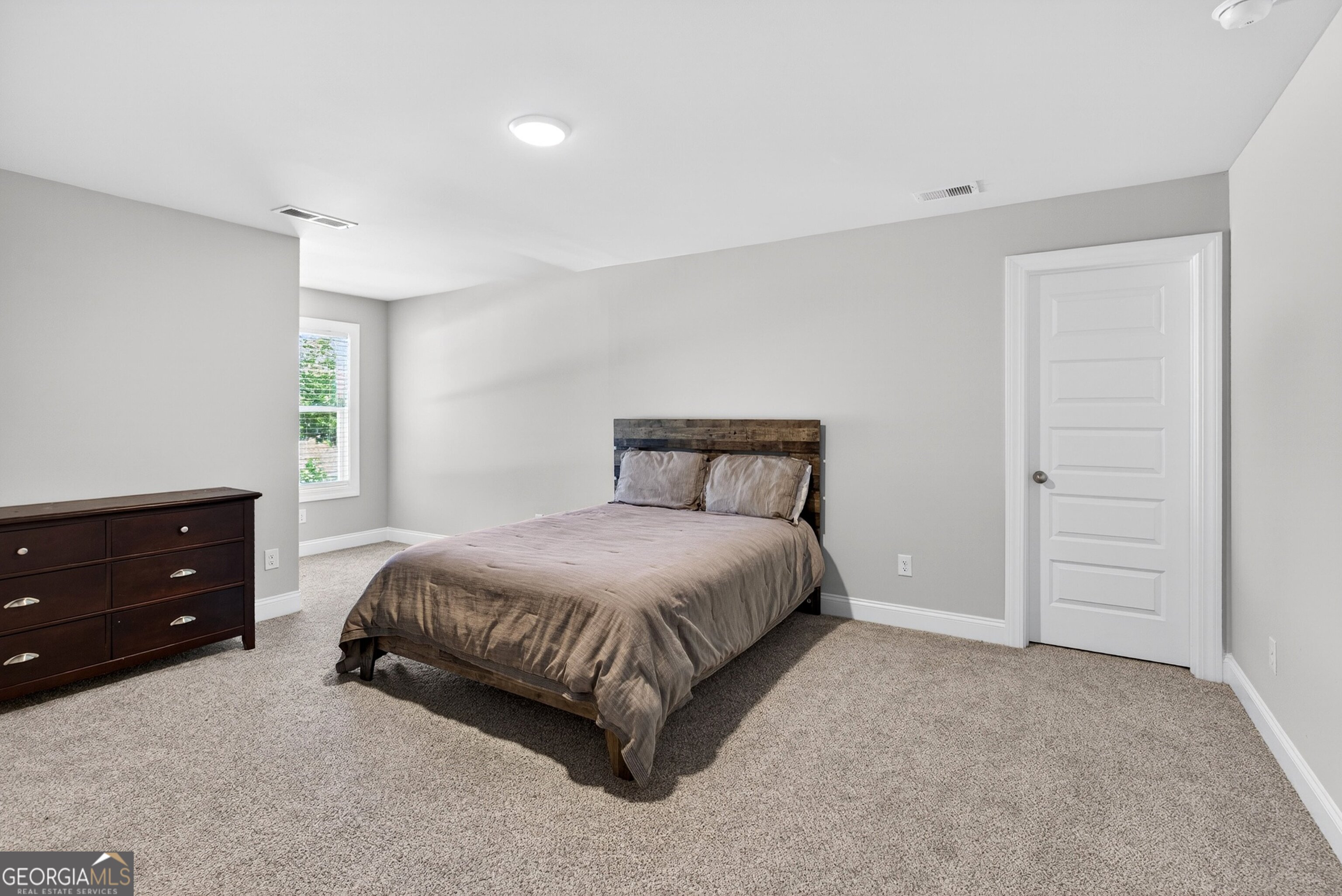 1764 Luther Bailey Road Senoia, GA 30276 - Photo 38 of 63 a bedroom with a bed and a dresser