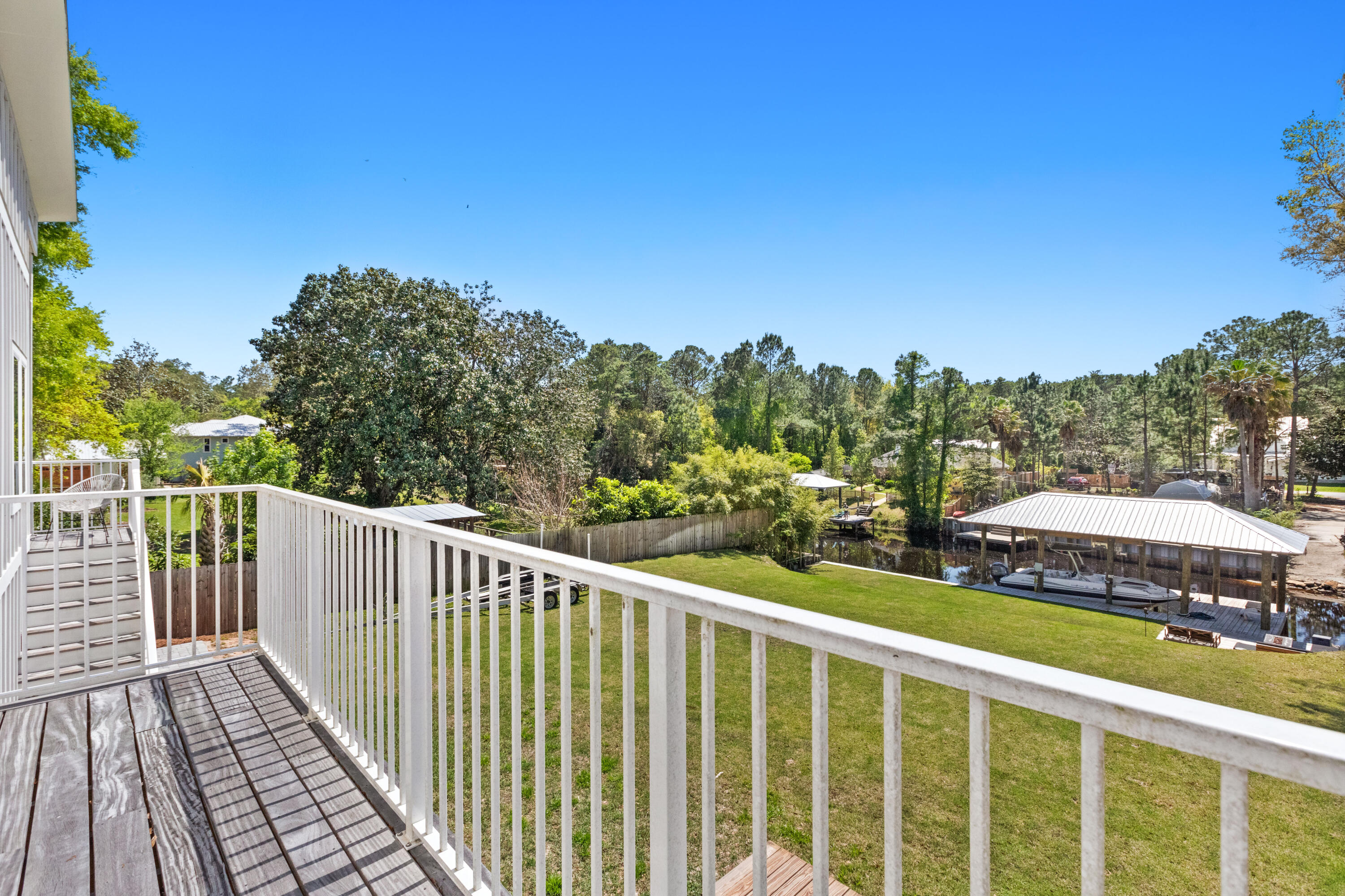 341 Little Canal Drive Santa Rosa Beach, FL 32459 - Photo 14 of 27 a view of a balcony with wooden floor and fence