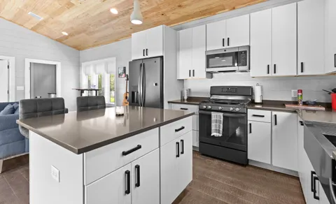 a kitchen with white cabinets stainless steel appliances and sink