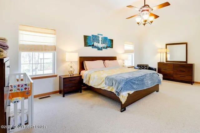 a bedroom with a bed dresser and a window