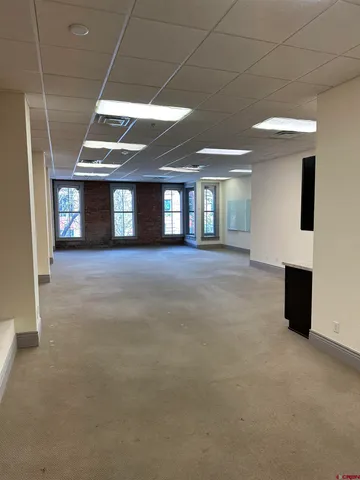 a view of an empty room with window and fireplace