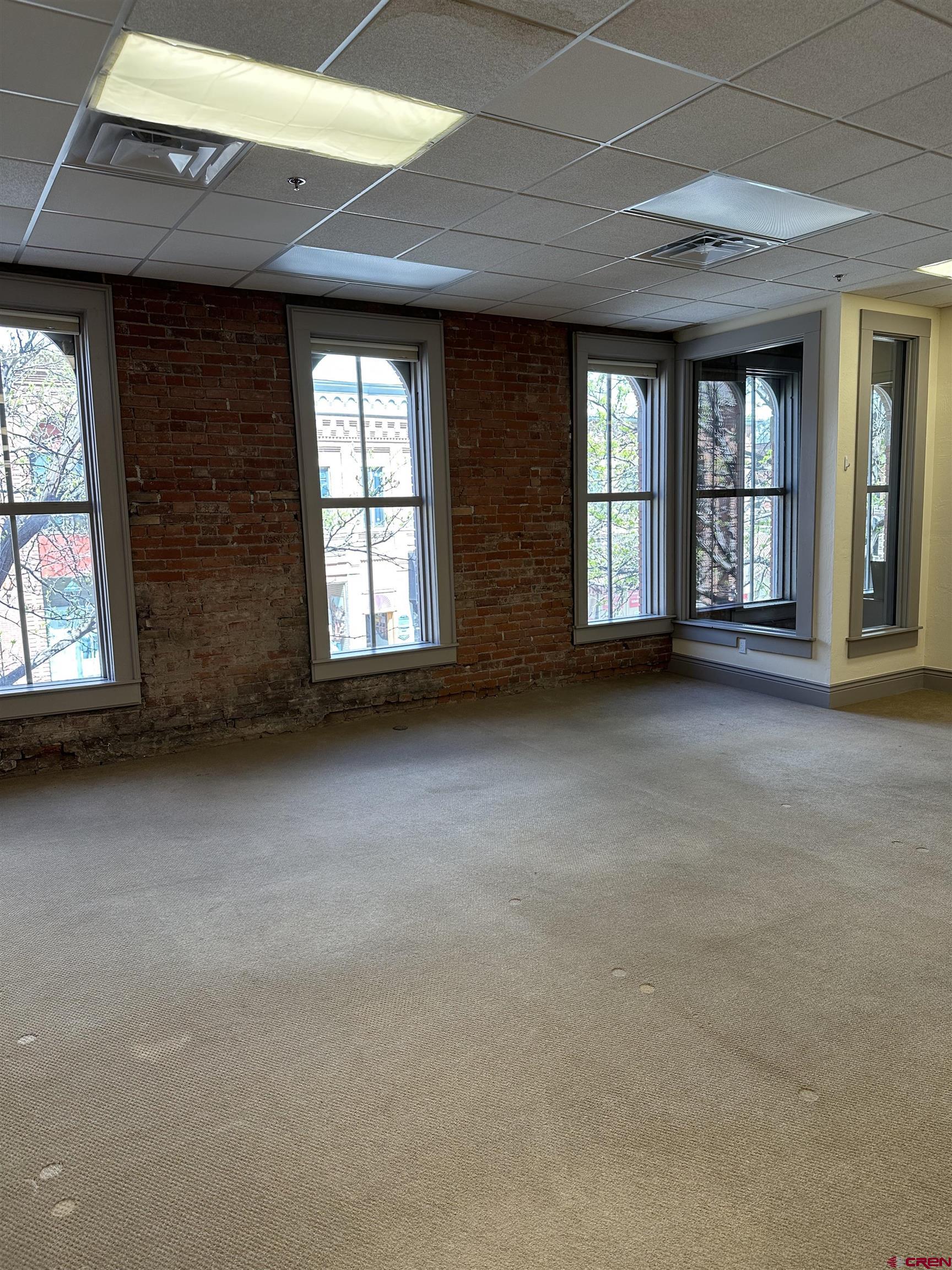 858 Main Avenue, Unit 202 Durango, CO 81301 - Photo 6 of 12 a view of an empty room with windows