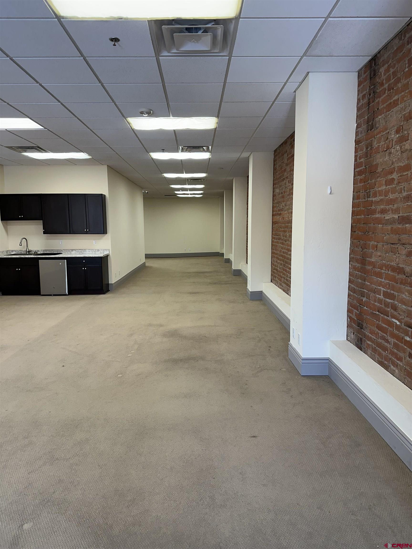 858 Main Avenue, Unit 202 Durango, CO 81301 - Photo 7 of 12 a view of an empty room with a fireplace