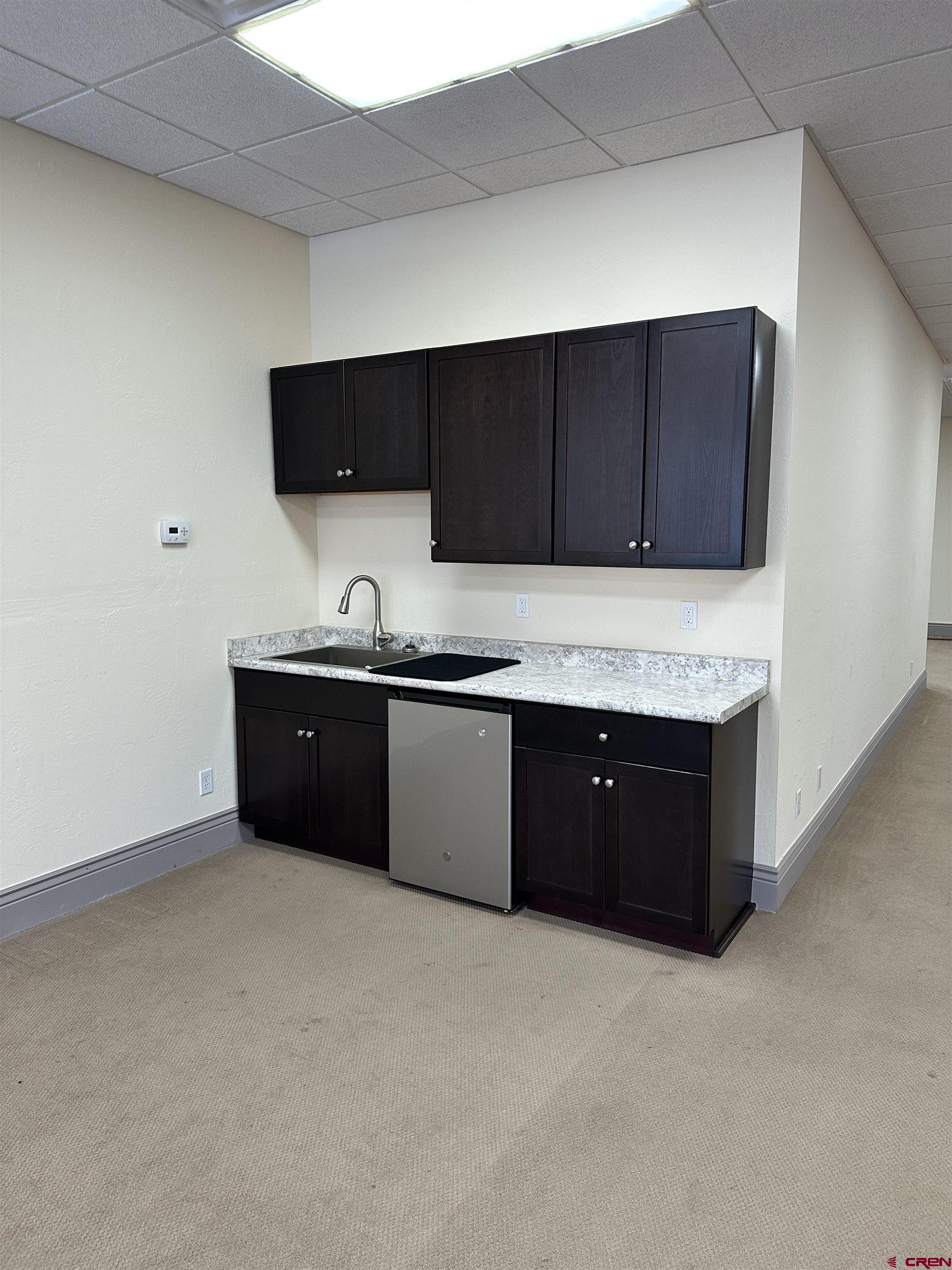 858 Main Avenue, Unit 202 Durango, CO 81301 - Photo 9 of 12 a kitchen with a sink and a cabinets