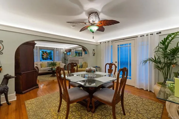 a dining room with furniture a rug and a chandelier