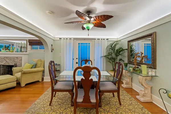 a dining room with furniture a rug and wooden floor