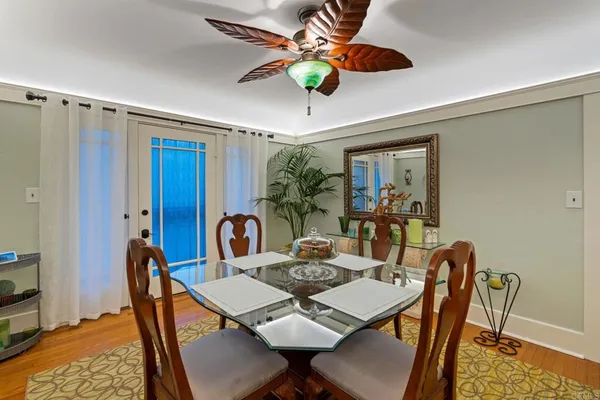 a dining room with furniture a chandelier and kitchen view