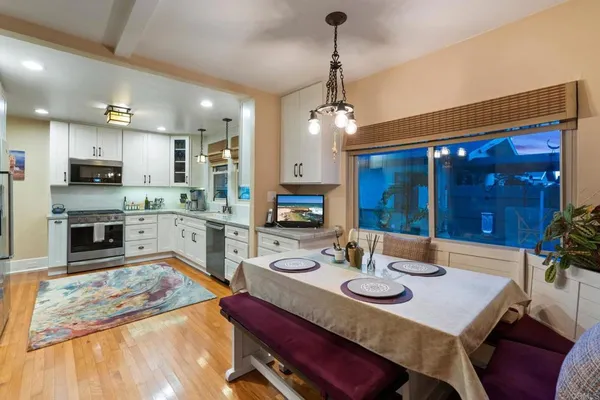 a kitchen with stainless steel appliances granite countertop a stove and cabinets