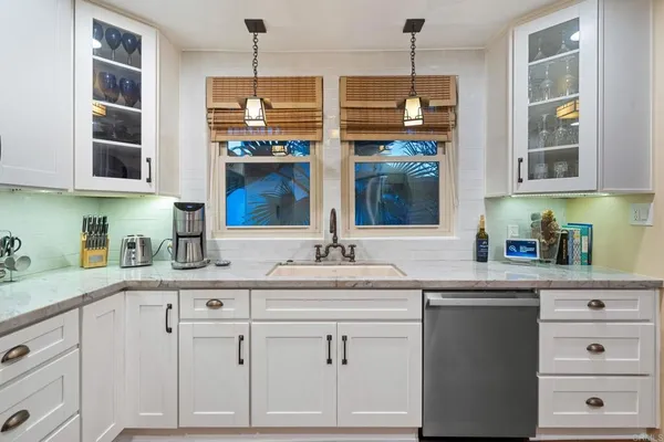 a view of a kitchen area with furniture and wooden floor