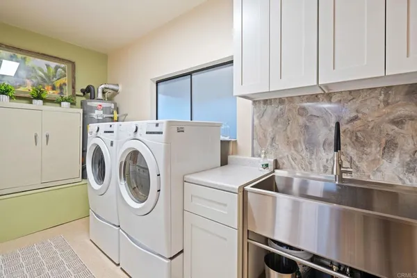 a kitchen with stainless steel appliances kitchen island granite countertop a refrigerator and a stove top oven