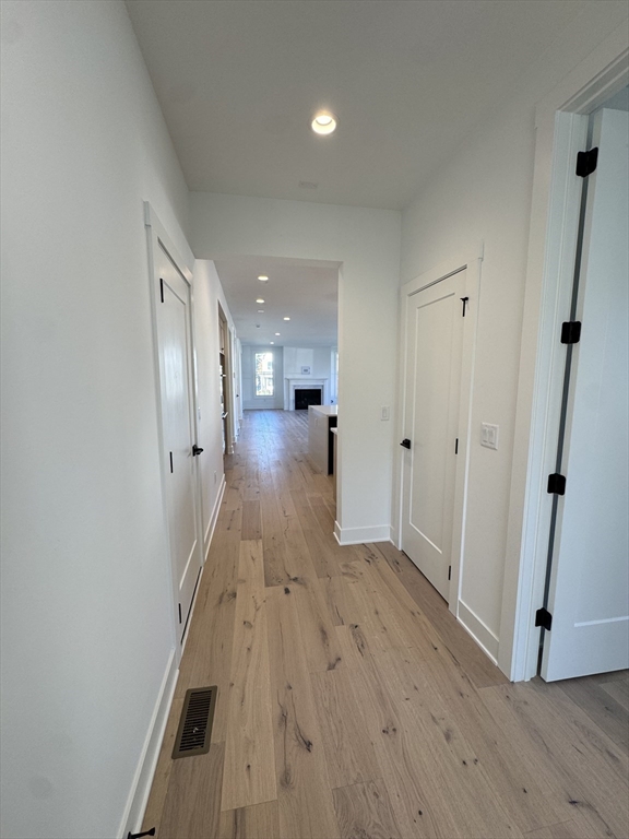 12 Old County Road, Unit 20 Hudson, MA 01749 - Photo 24 of 30 a view of a hallway with wooden floor and staircase